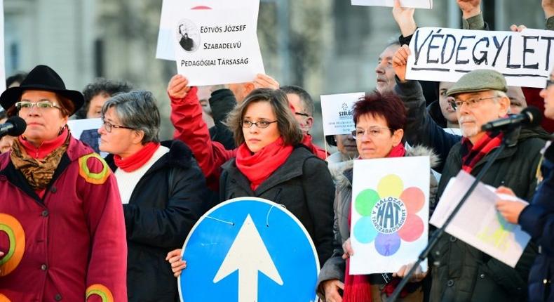 Activists of several non-governmental organizations show their logos during an anti-government demonstration in front of the Hungarian parliament in Budapest on February 5, 2017