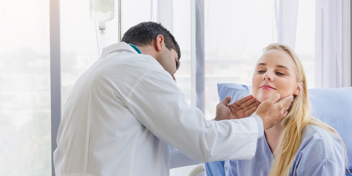 male doctor examined the neck pain of a female patient sitting