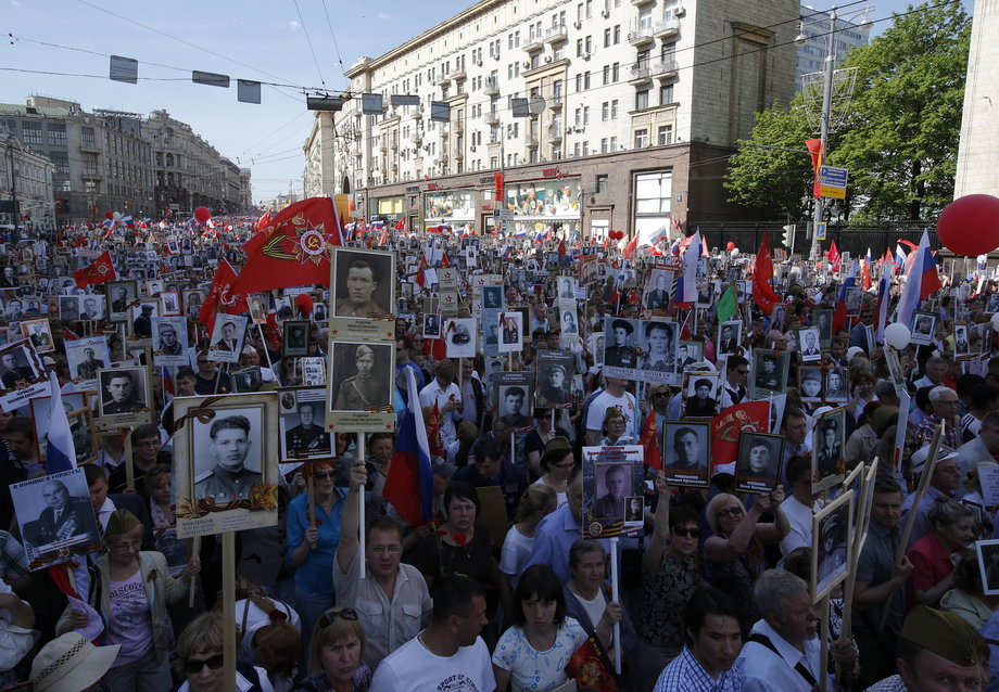 People hold pictures of World War Two soldiers as they take part in the Immortal Regiment march during the Victory Day celebrations, marking the 71st anniversary of the victory over Nazi Germany in World War Two, in central Moscow, Russia, May 9, 2016.