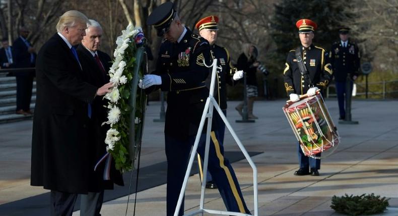 US President-elect Donald Trump and Vice President-elect Mike Pence take part in a wreath-laying ceremony at Arlington National Cemetery in Arlington, Virginia, on January 19, 2017