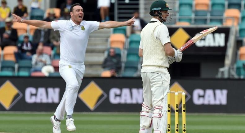 South Africa paceman Kyle Abbott (L) celebrates his wicket of Australia batsman Adam Voges (R) in Hobart on November 15, 2016