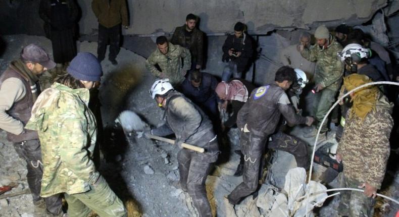 Syrian civil defence volunteers, known as the White Helmets, dig through the rubble of a mosque following a US air strike on the village of Al-Jineh late on March 16, 2017