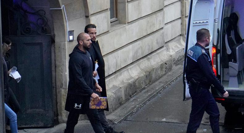 Andrew Tate, left, and Tristan Tate with Romanian police.Andreea Campeanu/Getty Images