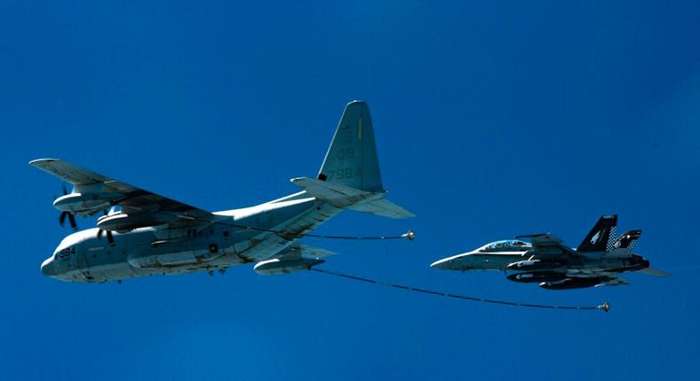 two F/A-18D Hornets with Marine All-Weather Fighter Attack Squadron 533 approach a KC-130J with Marine Aerial Refueler Transport Squadron 352 during a Special Purpose Marine Air-Ground Task Force - Crisis Response - Central Command aerial refueling exercise in undisclosed location.