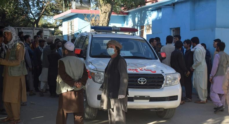 Afghans wait outside a hospital in Kabul for news of friends and family injured in a Taliban attack