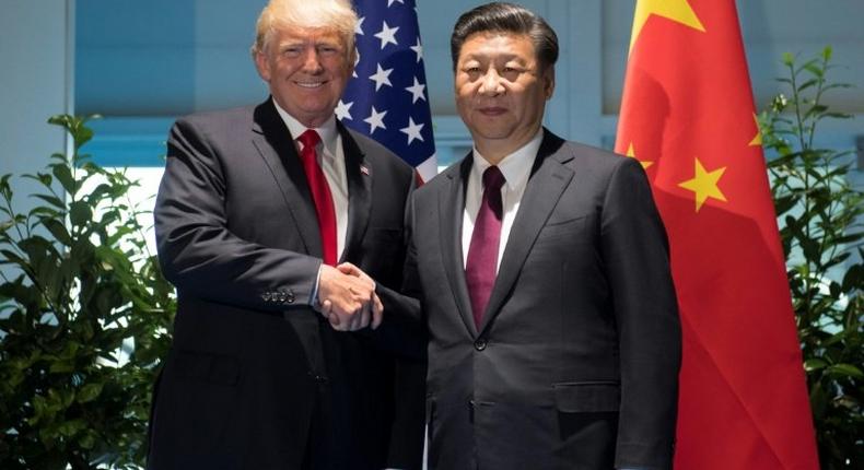 US President Donald Trump and Chinese President Xi Jinping (R) shake hands prior to a meeting on the sidelines of the G20 Summit in Hamburg, Germany on July 8, 2017