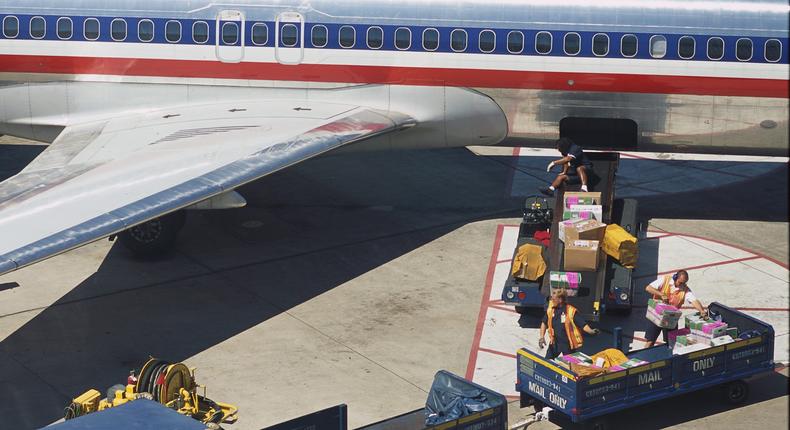 American Airlines' baggage handlers transport passengers' items at Dallas Fort Worth International Airport.Mark Peterson/Corbis via Getty Images