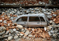 Car is seen covered under debris at a village following Saturday's earthquake in Sindhupalchowk