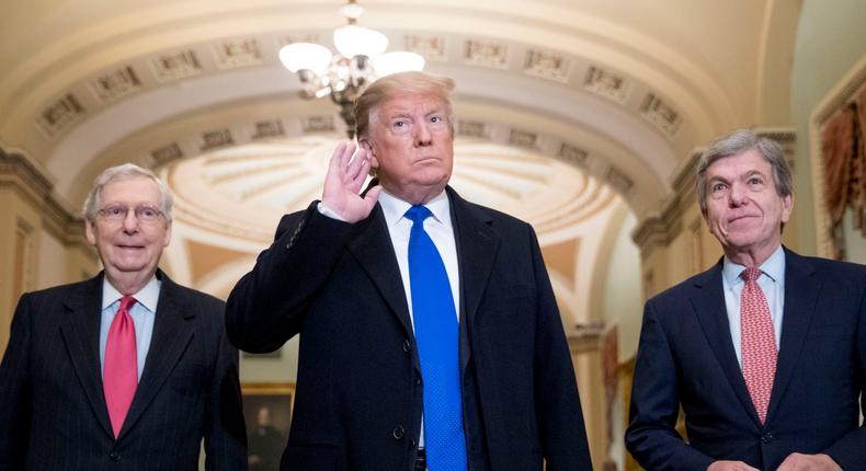 President Donald Trump accompanied by Senate Majority Leader Mitch McConnell of Ky., left, and Sen. Roy Blunt, R-Mo., right, takes a question from a member of the media as he arrives for a Senate Republican policy lunch on Capitol Hill in Washington, Tuesday, March 26, 2019. (AP Photo/Andrew Harnik)