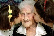 The World's oldest woman, Jeanne Calment, 120 years old, is kissed by two young girls during a speci