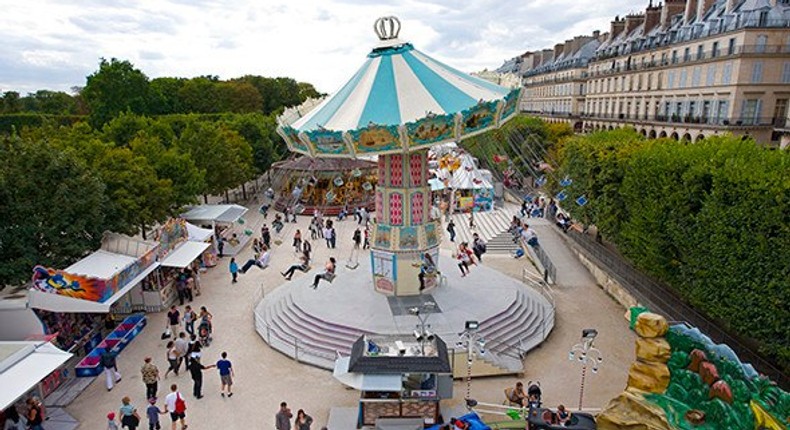 A carnival swings into Paris's Tuileries Garden each summer.