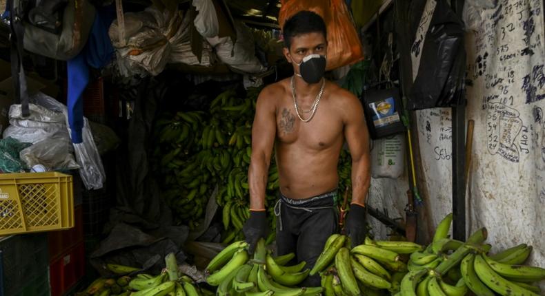 A man works at a market in Medellin, Colombia, on March 19, 2020