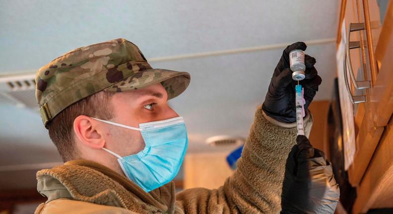 A soldier fills syringes with a Covid-19 vaccine in Londonderry, New Hampshire on February 4, 2021.
