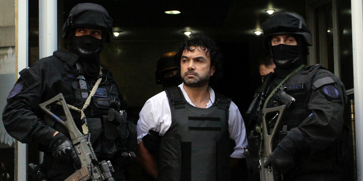 Argentine police escort Henry de Jesus Lopez Londoño outside a courthouse in Buenos Aires, October 31, 2012.