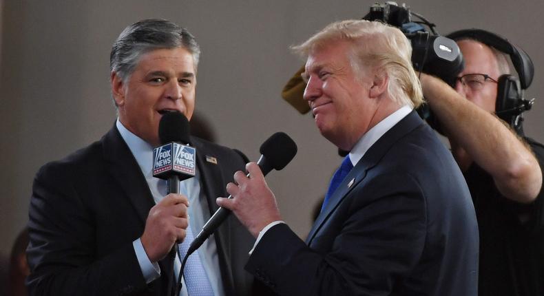 Fox News Channel and radio talk show host Sean Hannity (L) interviews U.S. President Donald Trump before a campaign rally at the Las Vegas Convention Center on September 20, 2018.