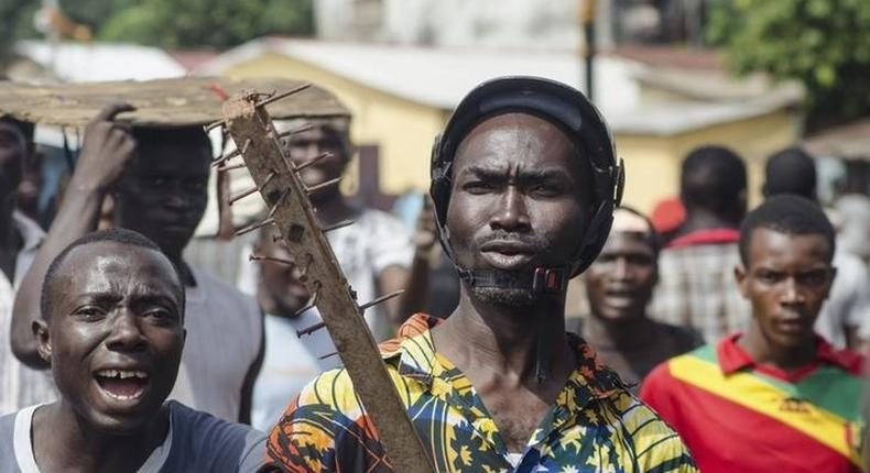 A pro-government protestor wields a homemade weapon during pre-election violence in the Taouyah neighbourhood of the Guinean capital Conakry, in a file photo. REUTERS/Tommy Trenchard