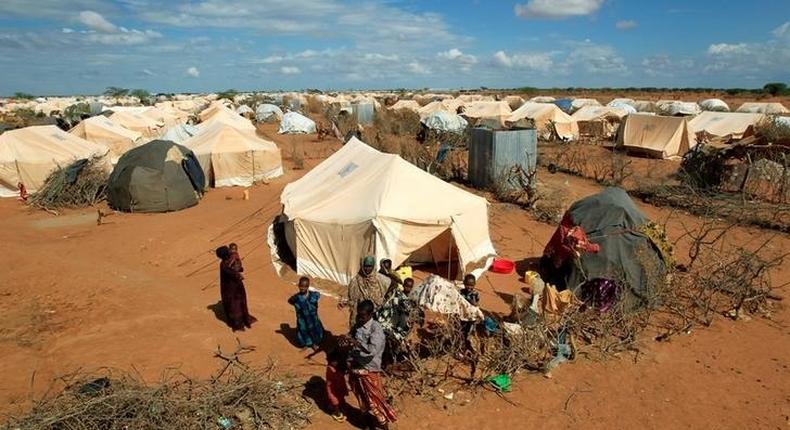 Refugees stand outside their tent at the Ifo Extension refugee camp in Dadaab, near the Kenya-Somalia border in Garissa County, Kenya October 19, 2011. 