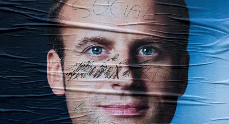 A vandalised campaign poster for French presidential election candidate Emmanuel Macron Emmanuel Macron is seen on May 5, 2017 in Paris