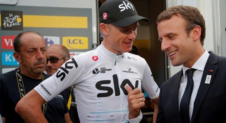 French President Emmanuel Macron (R) talks to overall leader, Britain's Chris Froome, after the 183km 17th stage of the 104th edition of the Tour de France cycling race, in Serre-Chevalier, on July 19, 2017