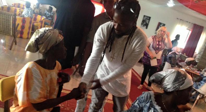 Samini donating his Xmas gift to the aged at Aya Community Clinic