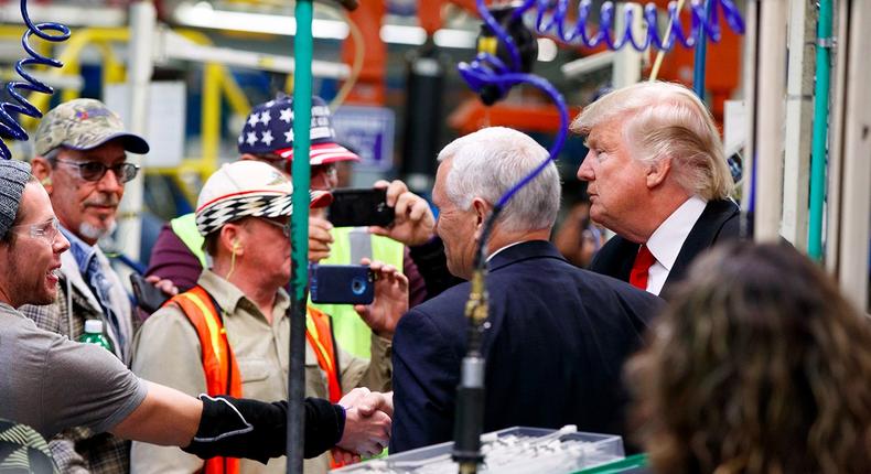 President-elect Donald Trump and Vice President-elect Mike Pence talk with factory workers during a visit to the Carrier factory, Thursday, Dec. 1, 2016, in Indianapolis, Ind.