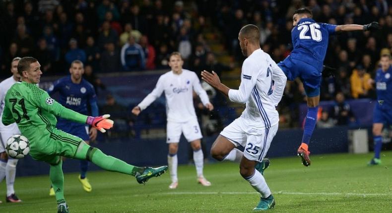 Leicester City's Riyad Mahrez (R) shoots past FC Copenhagen's goalkeeper Robin Olsen (L) to scores his team's first goal during at the King Power Stadium in Leicester, central England on October 18, 2016