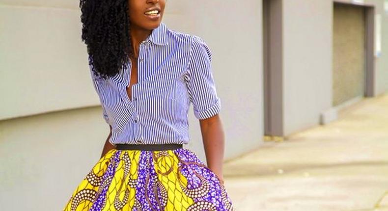 African woman rocking midi skirt and shirt