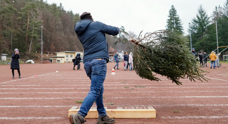 A participant hurls a spruce at the 16th World Christmas Tree Throwing Championship in Weidenthal, Germany. Kamila Grabska was photographed taking part in a similar competition in Ennis, Ireland, per The Irish Independent.Uwe Anspach/picture alliance via Getty Images