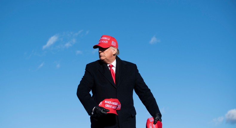 Then-President Donald Trump throws hats to supporters during a Make America Great Again rally at Wilkes-Barre Scranton International Airport November 2, 2020, in Avoca, Pennsylvania.