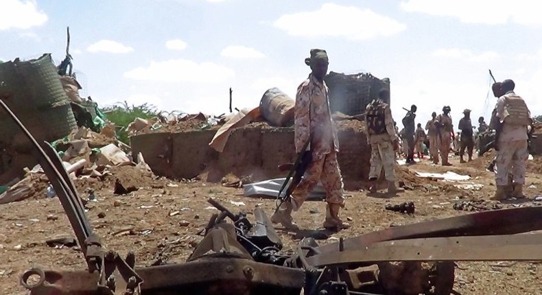 African Union soldiers from Djibouti stand at the site of a car bomb attack at an African Union army base in central Somalia on October 25, 2016