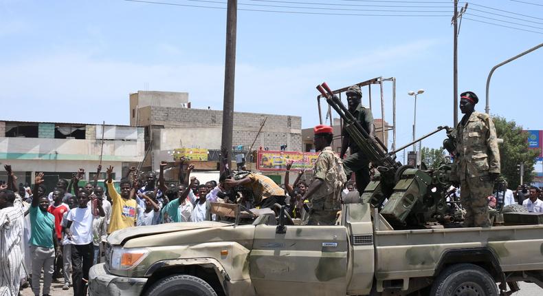 Sudanese greet army soldiers, loyal to army chief Abdel Fattah al-Burhan, in the Red Sea city of Port Sudan on April 16, 2023.AFP via Getty Images