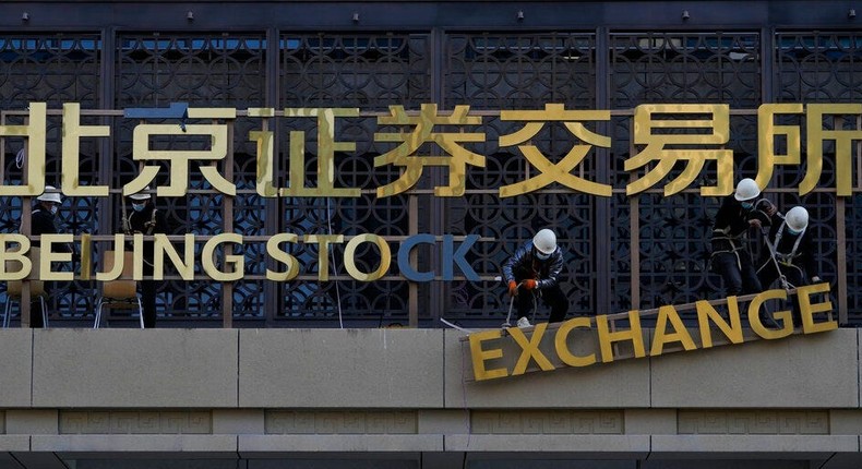 Workers install the nameplate of the Beijing Stock Exchange.Andy Wong/AP