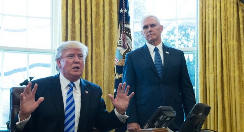 US President Donald Trump, with Vice President Mike Pence (R) speaks from the Oval Office of the White House in Washington, DC, on March 24, 2017