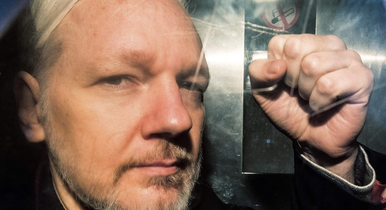 WikiLeaks founder Julian Assange gestures from the window of a prison van as he was driven into Southwark Crown Court in London in May 2019.DANIEL LEAL/AFP via Getty Images