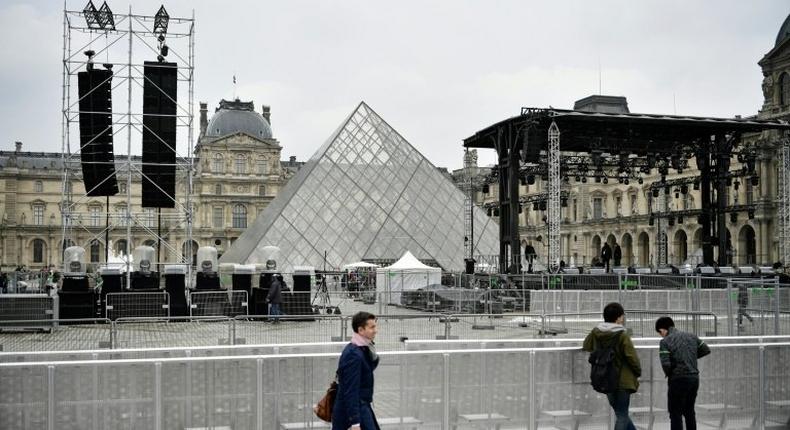 People walk through the courtyard of the Louvre following a security alert