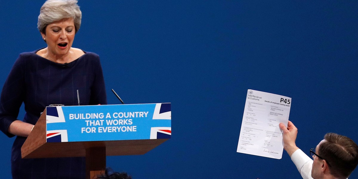 Theresa May handed a P45 by a protestor during conference speech