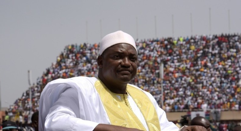 Gambian President Adama Barrow looks at the audience from the roof of a car as he arrives at the Independence Stadium in Bakau, west of the capital Banjul for his inauguration ceremony, on February 18, 2017