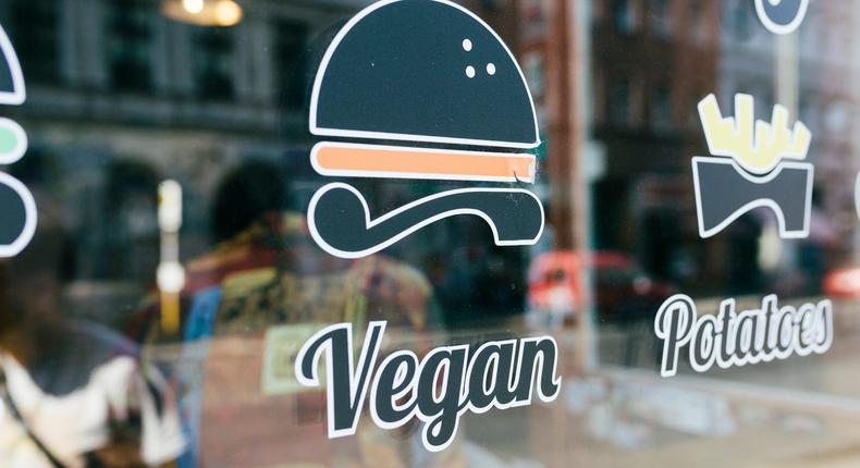 A vegan sign on a restaurant window.DigitalVision/Getty Images