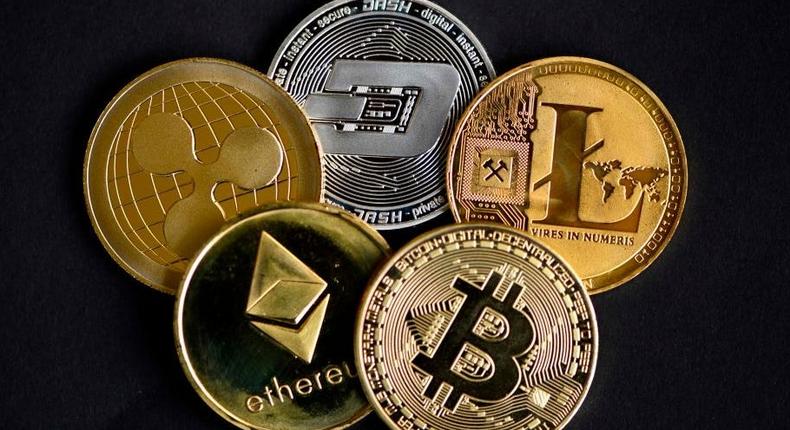 The photo shows physical imitations of cryptocurrency. INA FASSBENDER/AFP via Getty Images