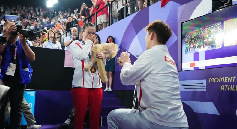 Badminton player Liu Yuchen proposes to gold medalist Huang Yaqiong after the medal ceremony following the Mixed Doubles Gold Medal Match on day seven of the Olympic GamesChina News Service/Getty Images