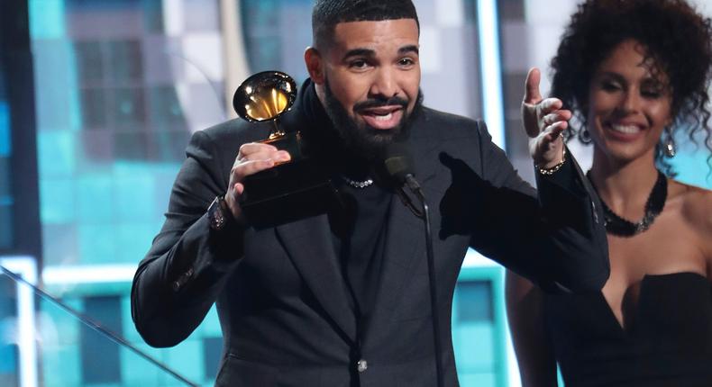 Drake accepts the award for best rap song for