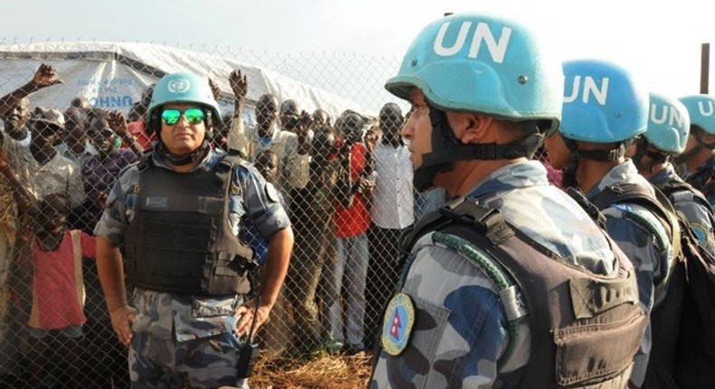 U.N. peacekeepers stand guard at a demonstration by people displaced in the recent fighting, during a visit by the United Nations Security Council, delegation to the UN House in Jebel, near South Sudan's capital Juba, September 3, 2016.