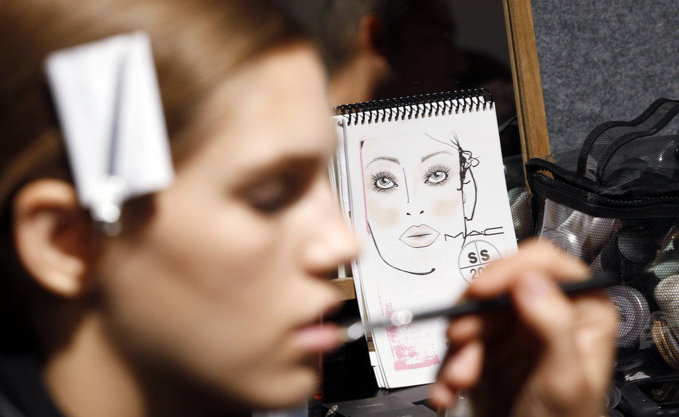 A model has her makeup applied backstage before the Dsquared2 Spring/Summer 2011 women's collection show during Milan Fashion Week