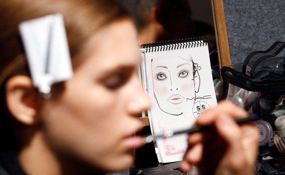 A model has her makeup applied backstage before the Dsquared2 Spring/Summer 2011 women's collection show during Milan Fashion Week