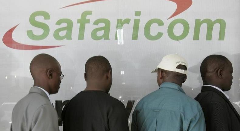 Kenyans line up outside a Safaricom building in a file photo. REUTERS/Antony Njuguna