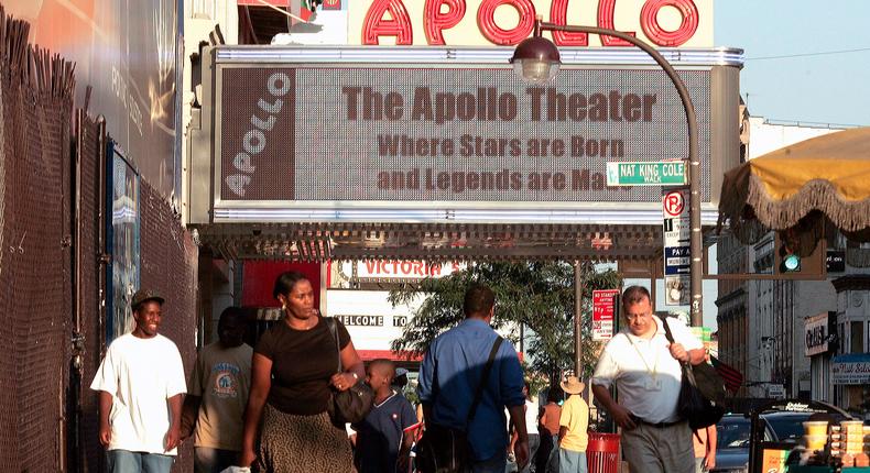 Pedestrians on 125th Street near the Apollo Theater in the Harlem neighborhood of New York.