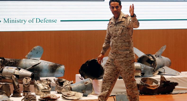 Saudi military spokesman Col. Turki al-Malki displays what he describes as an Iranian cruise missile and drones used in an attack this weekend that targeted the heart of Saudi Arabia's oil industry, during a press conference in Riyadh