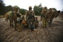 Participiants gather and listen to instructions during a territorial defence training organised by paramilitary group SJS Strzelec (Shooters Association) in the forest near Minsk Mazowiecki