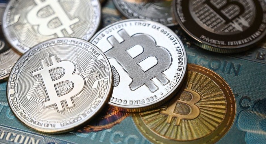 Bitcoin crypto currency physical banknote and coin imitations. 