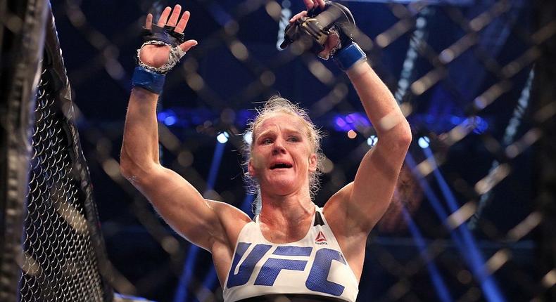 Holly Holm celebrates with her UFC belt after beating Ronda Rousey